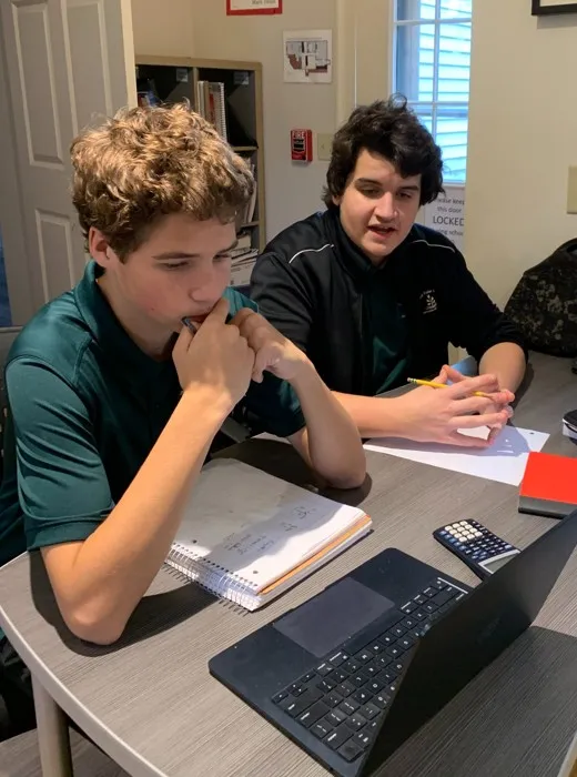 Upper school students working together at a table